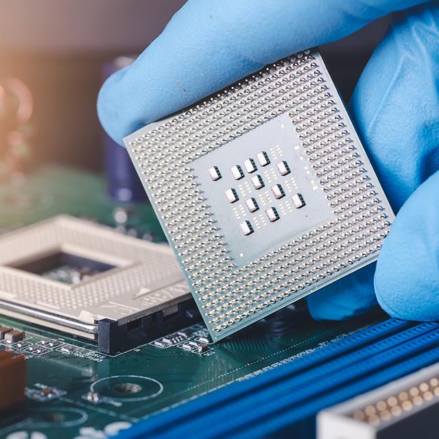 Electronics and Semiconductor Industry Lubricants – Technician Installing CPU onto Computer Motherboard Socket – Krytox™