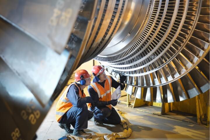 Engineers inspecting a large industrial turbine, representing Krytox™ lubricants' reliability in extreme environments